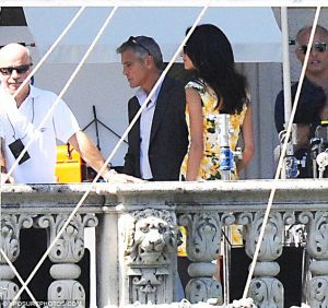 Amal Alamuddin in yellow floral dress watches fiancee George Clooney on set.jpg